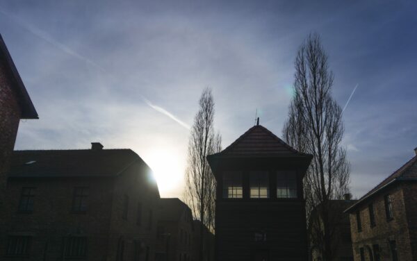 Memorial And Museum Auschwitz I, Sun Behind Prisoner Barracks And Guard Tower